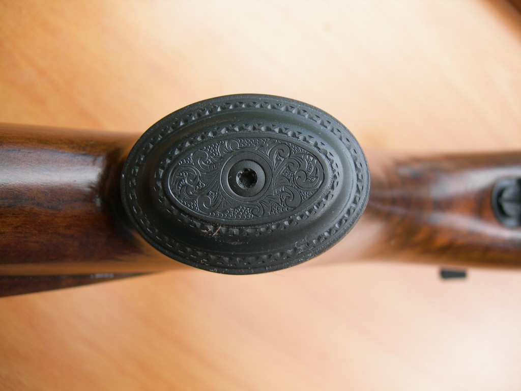 Engraved grip cap on .257 Roberts rifle