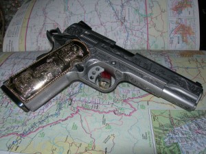 Engraved Smith and Wesson 1911 with gold grips.