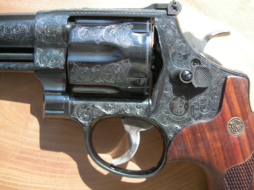A Smith & Wesson Model 57 with American Scroll engraving  covering 3/4 of the firearm.