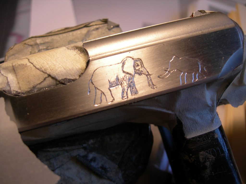 A work in progress of a PPK/S with elephants engraved on the slide.