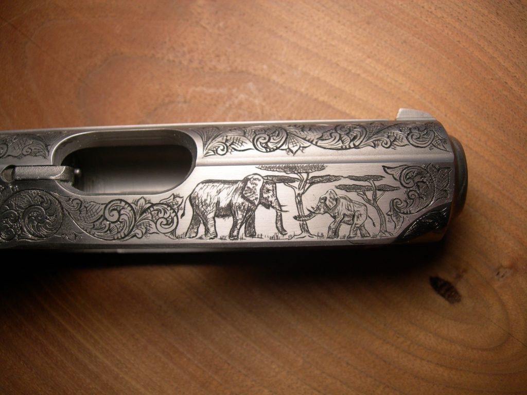 Elephants engraved on the slide of a PPK/S. The elephants are no more than 1/2 inch!