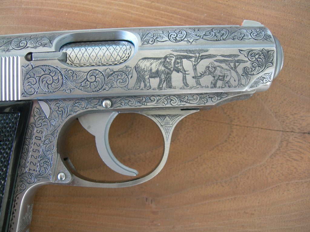 Finished engraving of an InterArms PPK/S featuring American Scroll engraving and elephants.