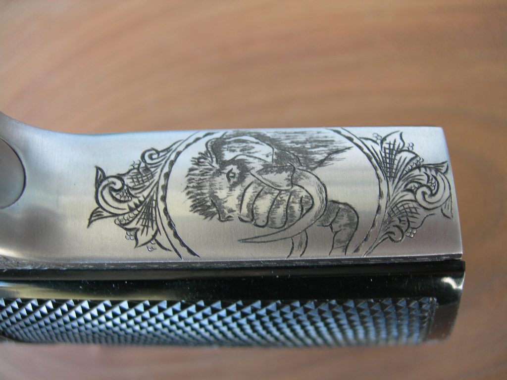 A mammoth head surrounded by an American Scroll engraved frame on an InterArms PPK/S