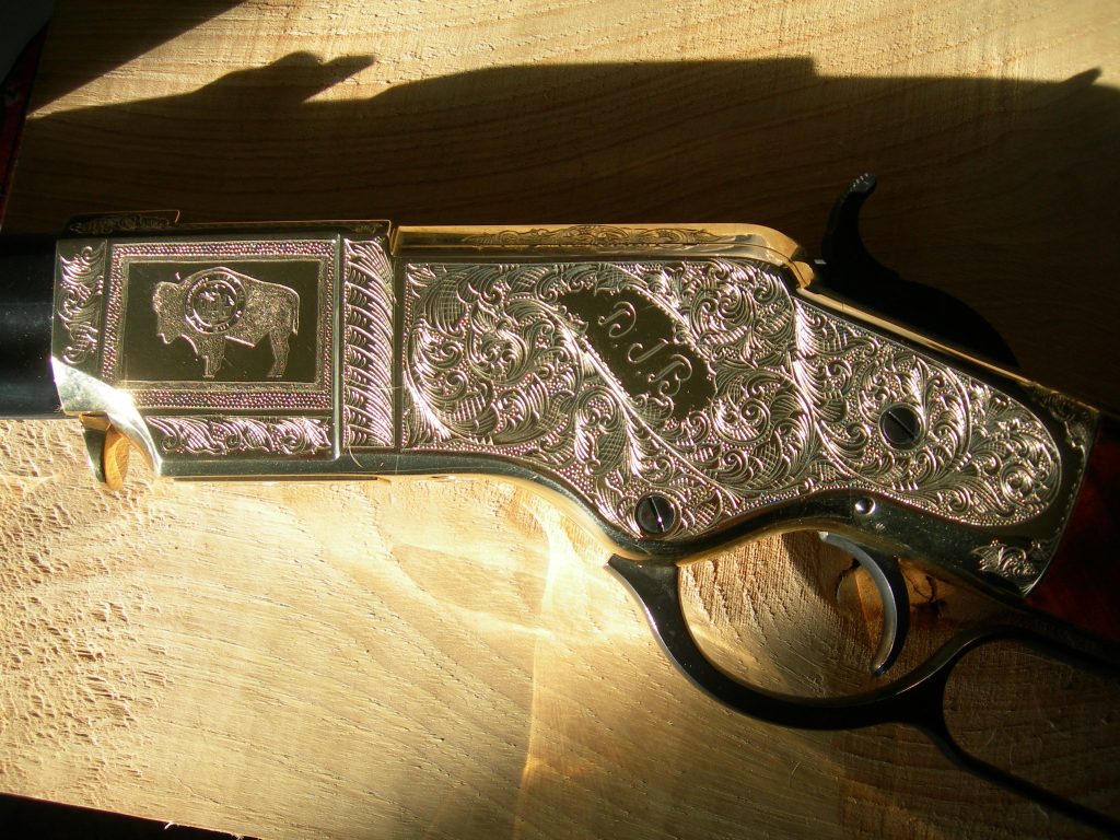 Engraved un-inked cuts on a Henry rifle.