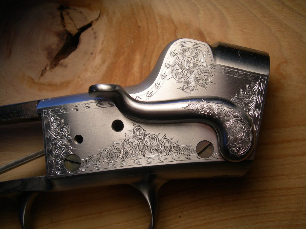 DZ Arms Hepburn action. Engraved in American Scroll at about 50% coverage.